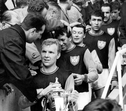 Captain Booby Moore descends the Wembley steps with the FA Cup