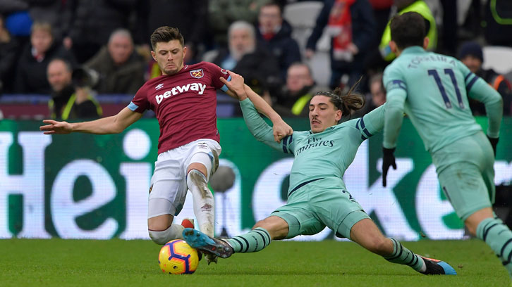 Aaron Cresswell challenges Arsenal's Hector Bellerin