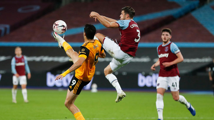 Aaron Cresswell challenges Raul Jimenez