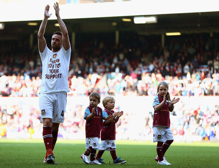 Kevin Nolan and his children applaud the Claret and Blue Army