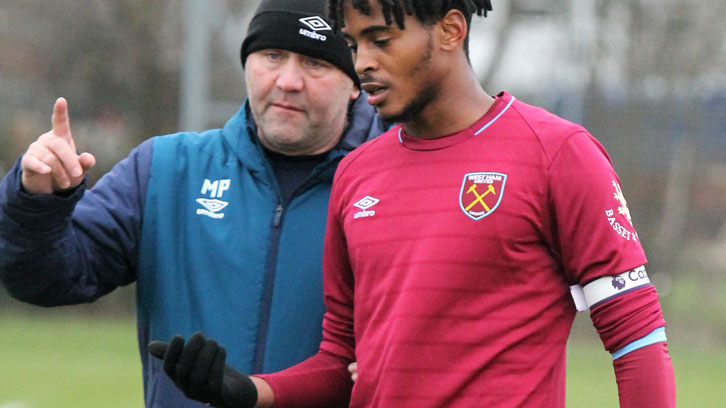 Lead U18s coach Mark Phillips talks to centre-back Josh Okotcha