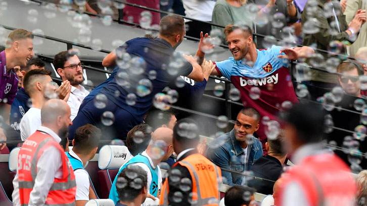 Andriy Yarmolenko celebrates scoring against Norwich with the medical staff